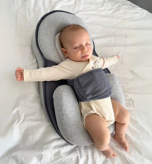 Baby resting in the inclined baby nest